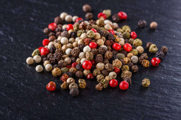 istock mix of peppercorns on a dark stone background 1211321547