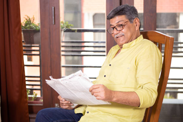 Senior Man Reading Newspaper and having coffee