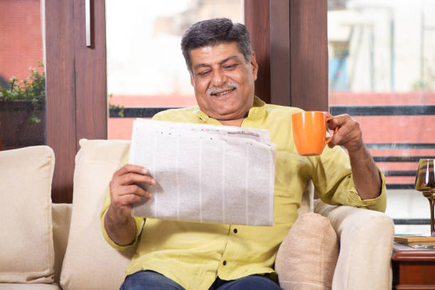 istock Senior Man Reading Newspaper and having coffee 1211321674