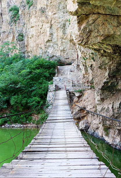 istock Hanging bridge across the lake 121132168