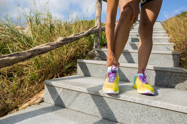 young woman trail runner hold her sports injured leg outdoor - railing beautiful human leg people imagens e fotografias de stock