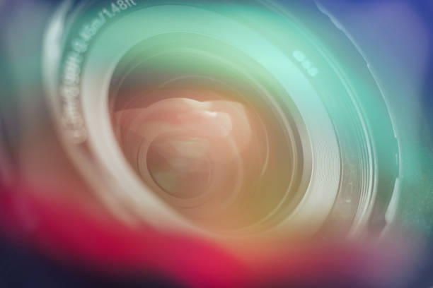 istock Beautiful camera lens with multi colored light of glass. Background pattern for design. 1211323015