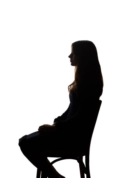 istock Beautiful young girl sitting on a chair - silhouette, isolate 1211323156