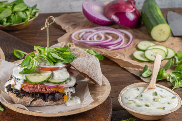 istock Healthy vegan burger with fresh vegetables and yogurt sauce 1211323232