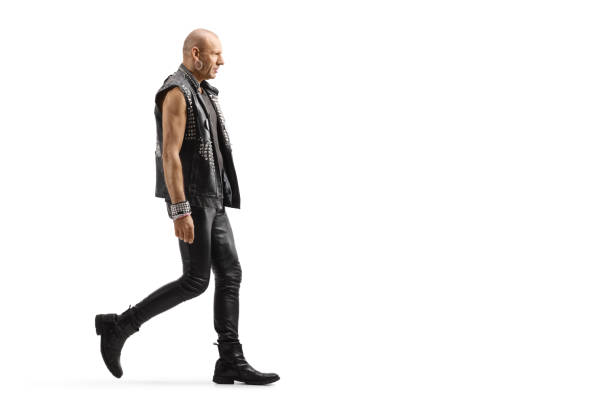istock Bald punk man in leather clothes walking 1211323312