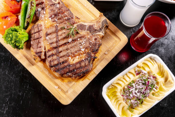 istock Beef steak fried grill (delicious meat, sliced ​​portion serving, roast rare) and raki 1211323428