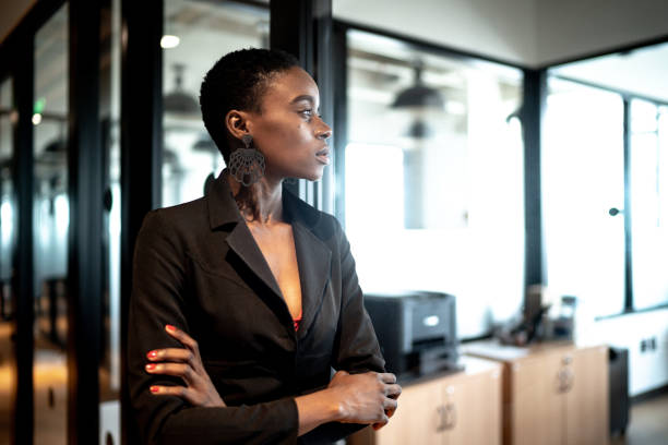 Young businesswoman looking away Young businesswoman looking away employee encouragement stock pictures, royalty-free photos & images