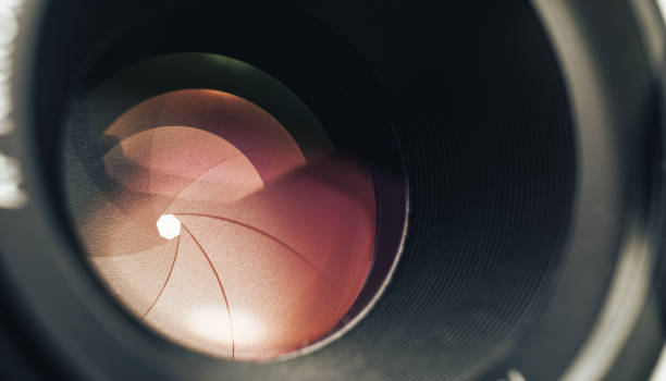 istock Beautiful camera lens with pink light of glass. Background pattern for design. 1211323592