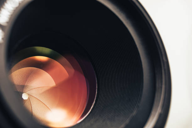 istock Beautiful camera lens with orange  light of glass. Background pattern for design. 1211324122