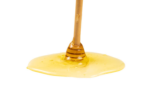 istock Dipper with honey isolated on white background. 1211324128