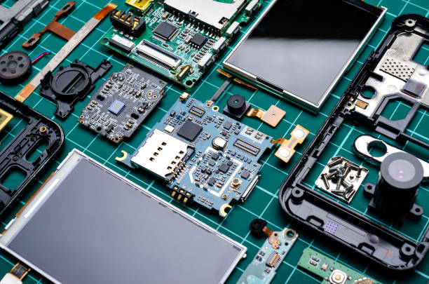 istock Boards and components of disassembled old mobile phones with semiconductor elements 1211324320