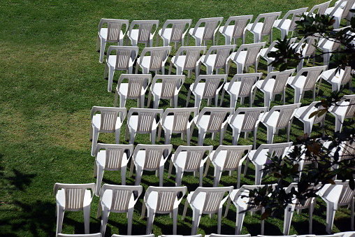 Plastic chairs arrangement for an outdoor event, outdoor atmosphere makes an event more joyful and pleasant