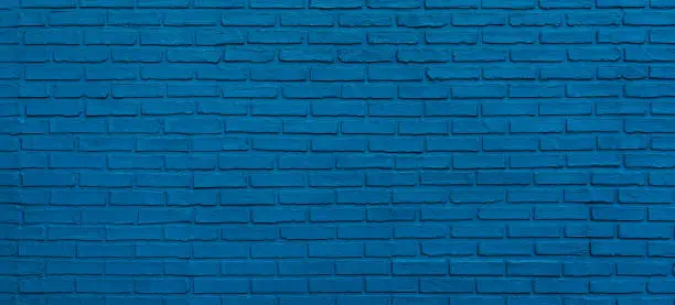 Photo of panoramic brick wall painted blue