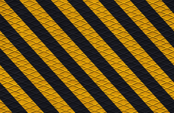 black and yellow safety hazard attention warning stripes on diamond metal texture black and yellow safety hazard attention warning stripes on diamond metal texture warning coloration stock pictures, royalty-free photos & images