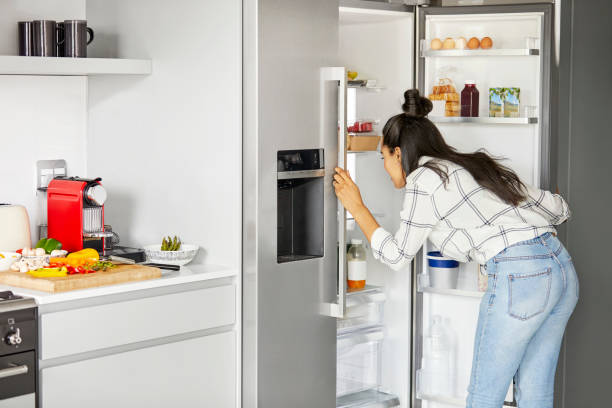 istock Woman searching for ingredient in refrigerator 1211324823