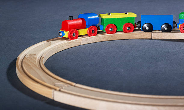 istock colorful wooden toy train on tracks 121132504