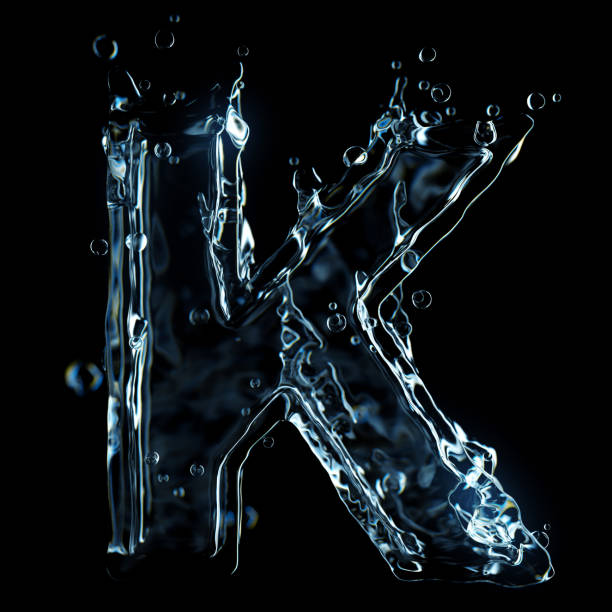 istock Liquid letter K water splash isolated on black background 1211325598