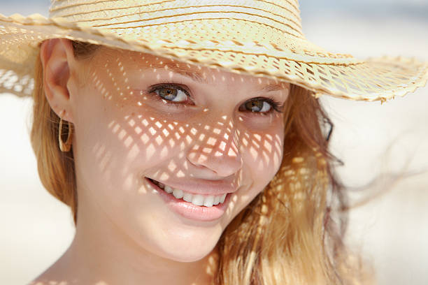 istock woman in straw hat smiling at camera 121132586