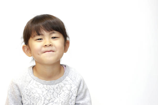 istock smiling Japanese girl (5 years old) (white back) 1211326175