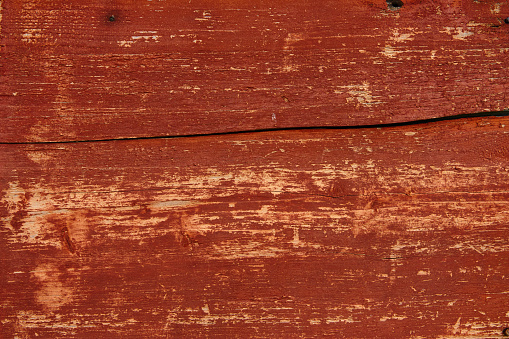wooden wall of old house, painted red color, natural wood texture or background