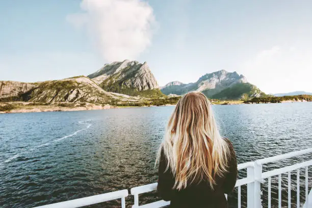 Photo of Woman tourist traveling by sea ferry in Norway landscape Travel Lifestyle concept adventure weekend vacations outdoor
