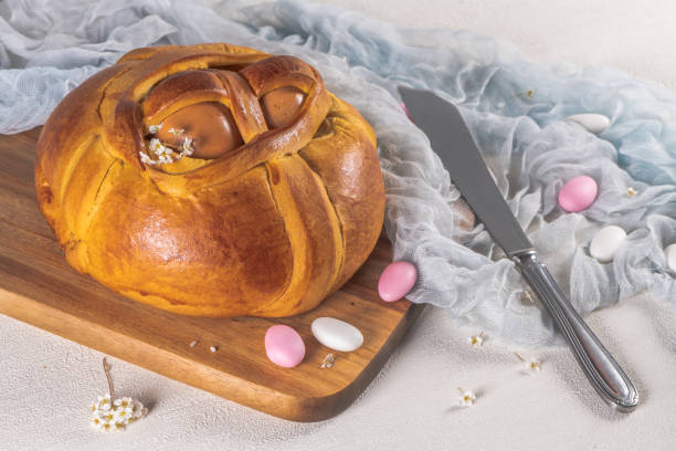 istock Portuguese traditional Easter cake. Folar with eggs on wooden table 1211330603
