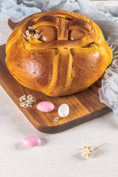 istock Portuguese traditional Easter cake. Folar with eggs on wooden table 1211330813