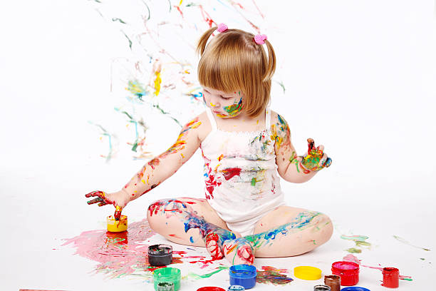 istock little girl bedaubed with bright colors 121133116