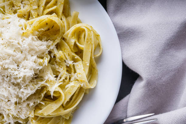 istock Delicious tagliatelle pasta with pesnto sauce on dark stone background 1211331885