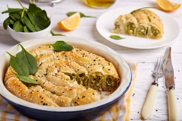 delicious pie with spinach and feta cheese, made from filo pastry, decorated with sesame seeds - pie spinach spanakopita filo pastry imagens e fotografias de stock