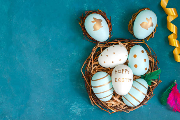 istock Easter background with Easter eggs in bird nest on blue background 1211332590
