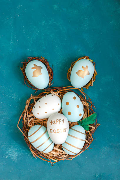 istock Easter background with Easter eggs in bird nest on blue background 1211332593