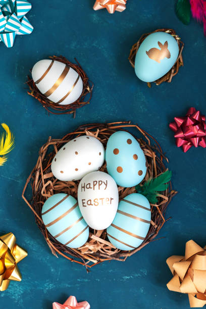 istock Easter background with Easter eggs in bird nest on blue background 1211332594