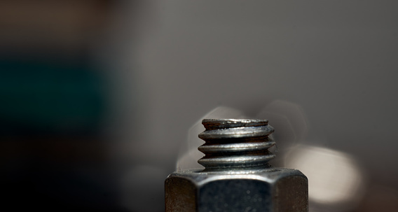 A closeup shot of a small screw with a blurred background