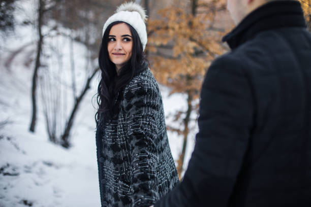 Romantic couple is walking in the winter park