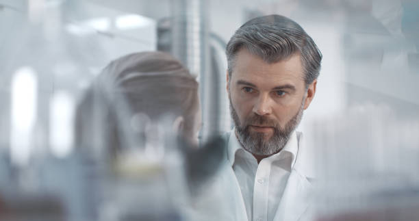 istock Man and woman are talking in the laboratory 1211334169