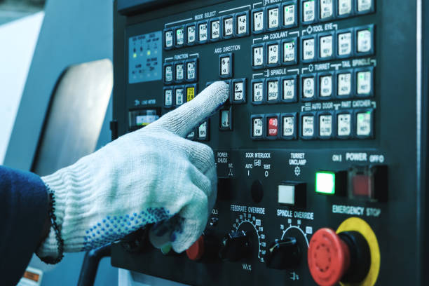 istock A gloved operator’s hand presses a button on the CNC control panel of the machine 1211335176