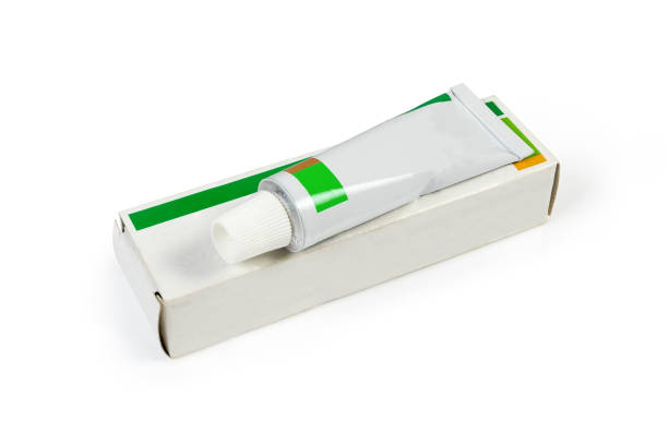 istock Box and tube with healing ointment on white background 1211335186
