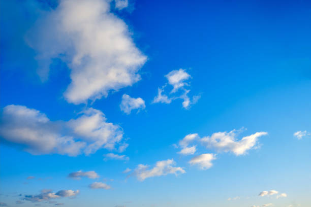 istock White clouds against a blue sky, copy space. Cloudy sky in clear weather. Cumulus cloud on a sunny winter day. 1211335247