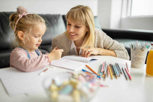 istock Mother helping child with art homework 1211335290