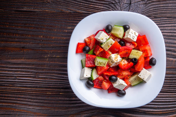 istock greek salad on dark wooden rustic background 1211335352