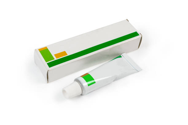 Box and tube with healing ointment on white background Tube pack of healing ointment and his cardboard box on a white background ointment photos stock pictures, royalty-free photos & images