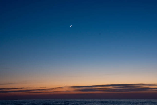 istock Sea sunset and crescent moon 1211337297
