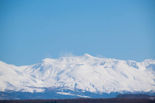istock Snowy mountain peaks and blue sky 1211337866