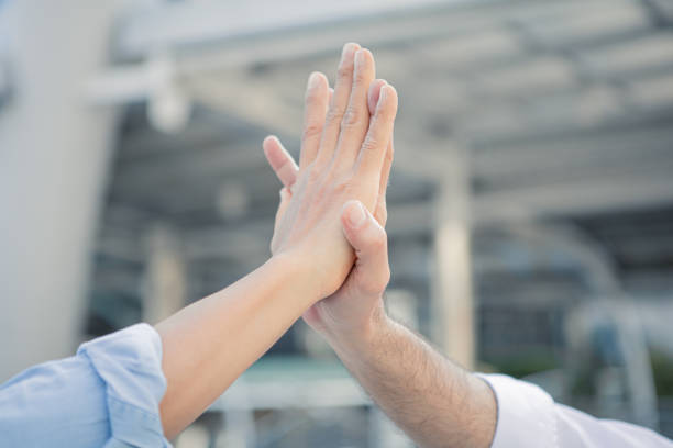 Successful businessman join hands after good deal in the city. Business partnership concept. Join hands.