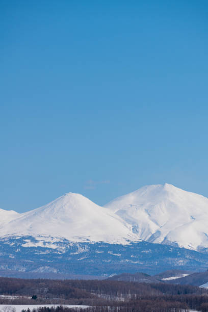 istock Snowy mountain peaks and blue sky 1211338071