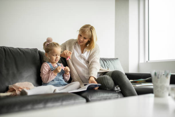 istock Mother and daughter drawing 1211338662