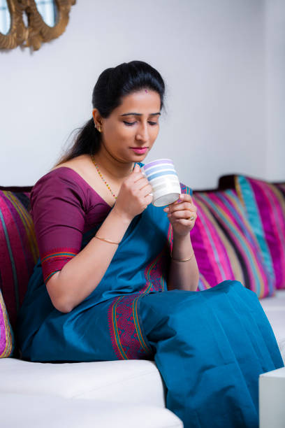 istock Woman Sitting On Sofa stock photo 1211338741