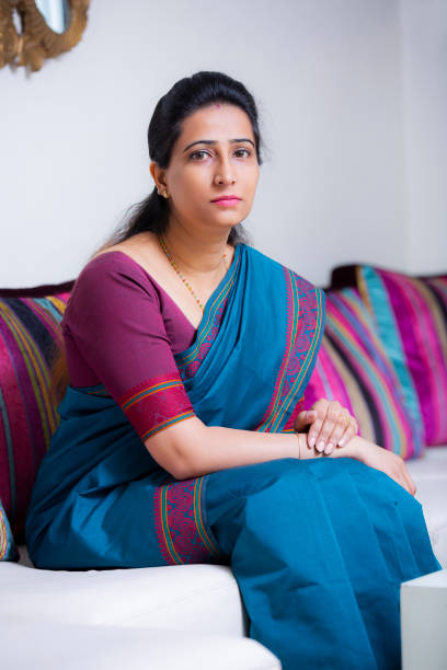 istock Woman Sitting On Sofa stock photo 1211338901