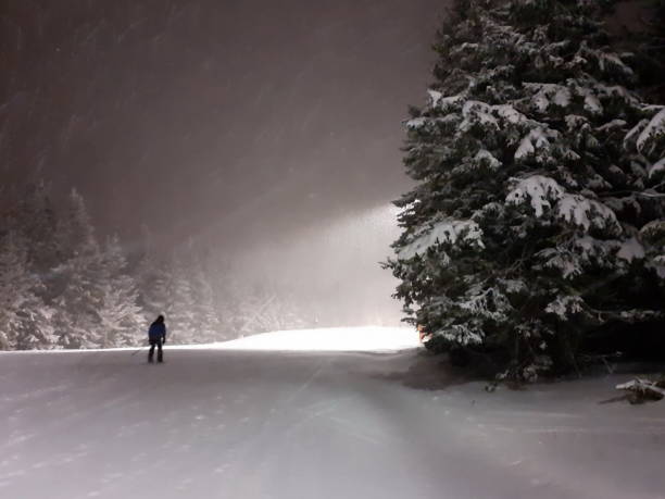 istock Night skiing with lights , skier on the ski slope 1211338993